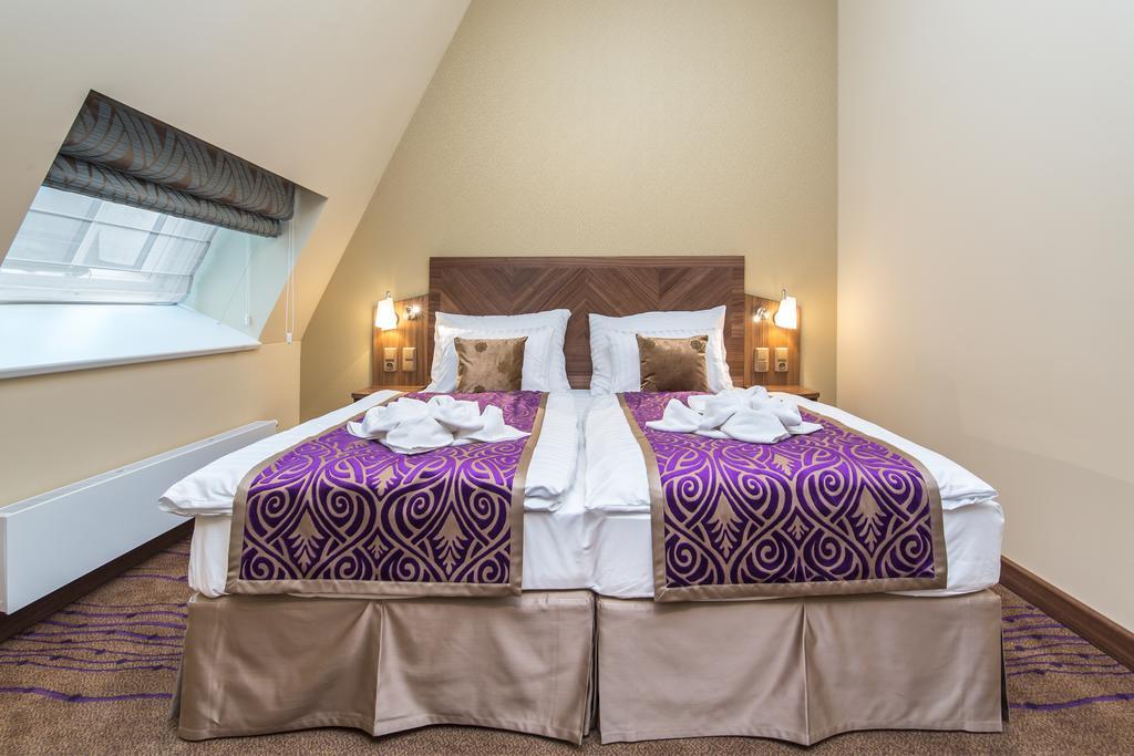 Merchants Crown Suites And Spa Praga Zewnętrze zdjęcie A bed with a bed skirt